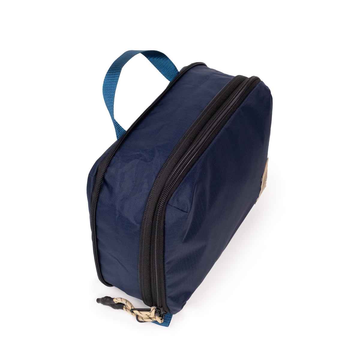 Top quarter detail white background image of Topo Designs Global Compression Pack Bag Set in "Navy / Sahara"