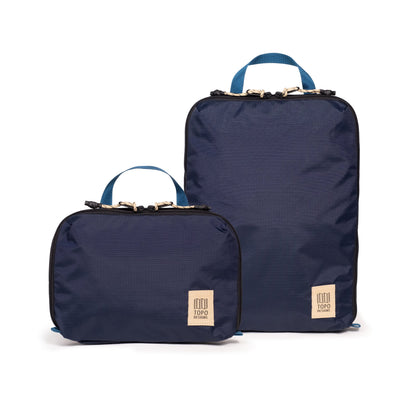 Front white background image of Topo Designs Global Compression Pack Bag Set in "Navy / Sahara"