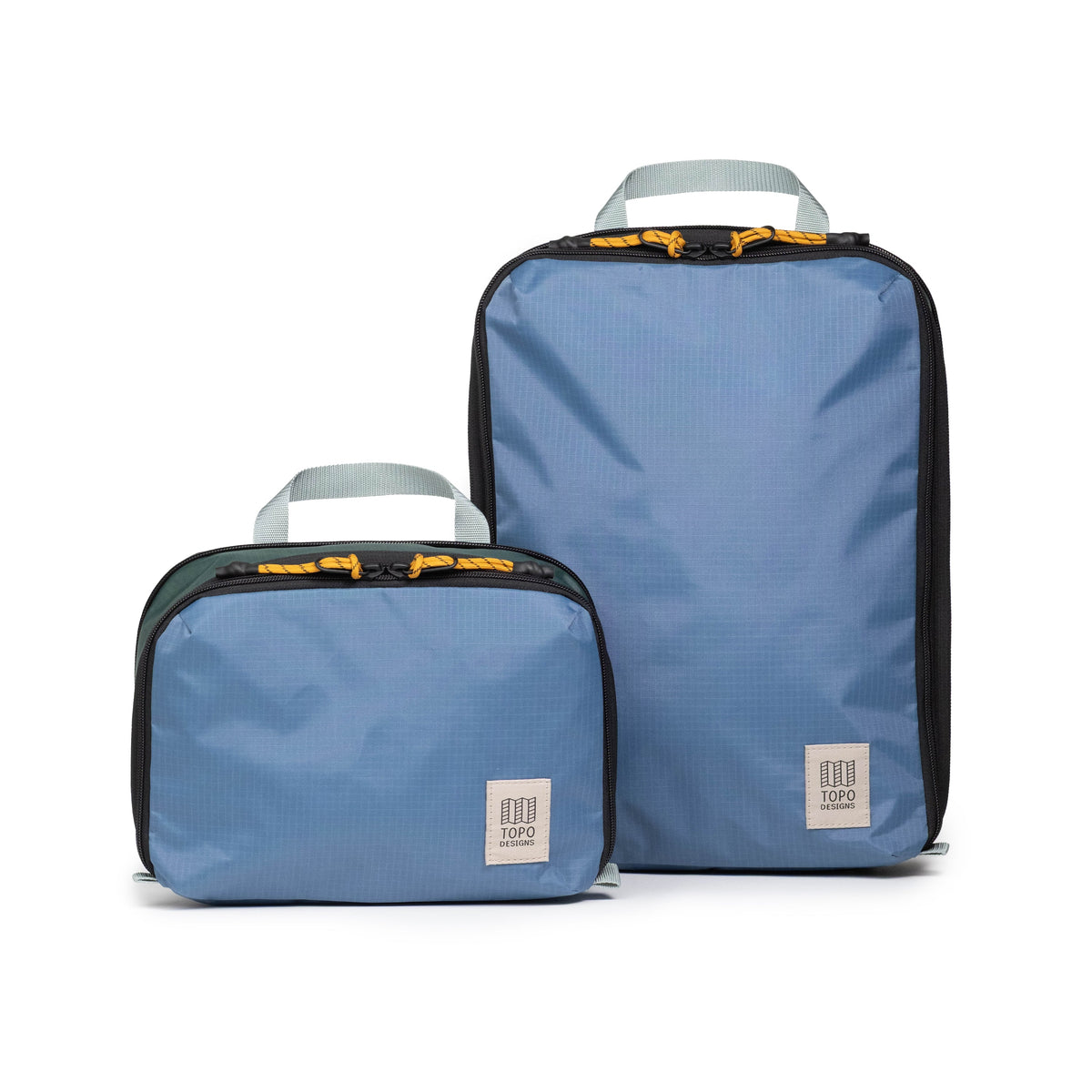 Front white background image of Topo Designs Global Compression Pack Bag Set in "Stone Blue / Forest"