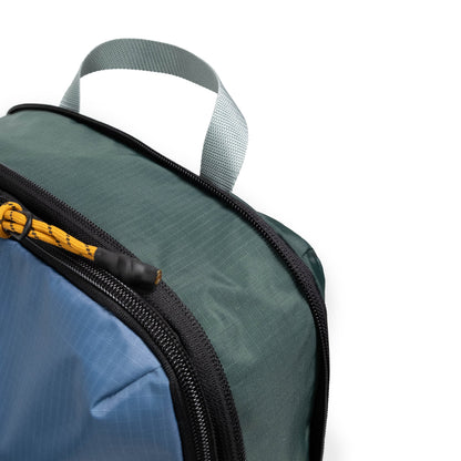 Front zipper detail white background image of Topo Designs Global Compression Pack Bag Set in "Stone Blue / Forest"